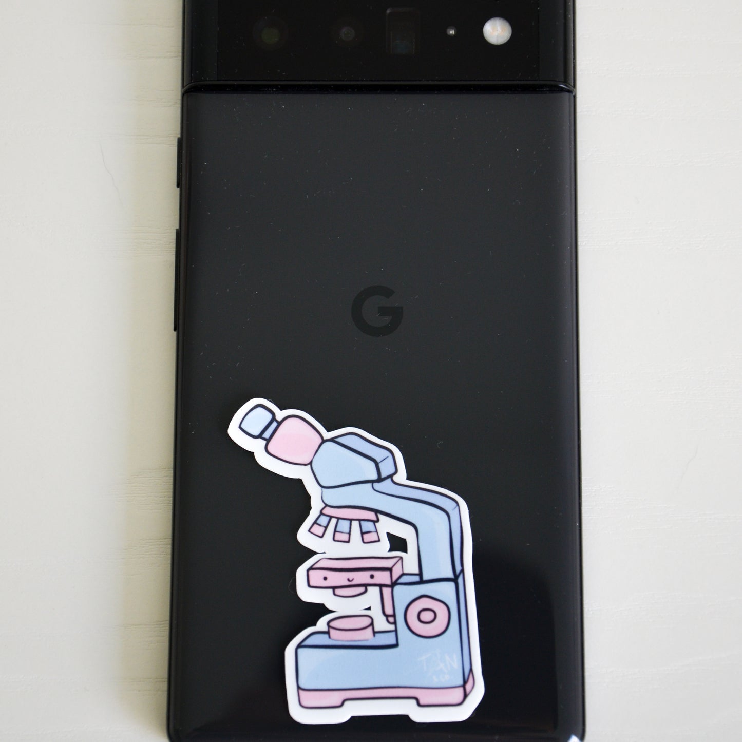 Pink and blue microscope sticker on phone