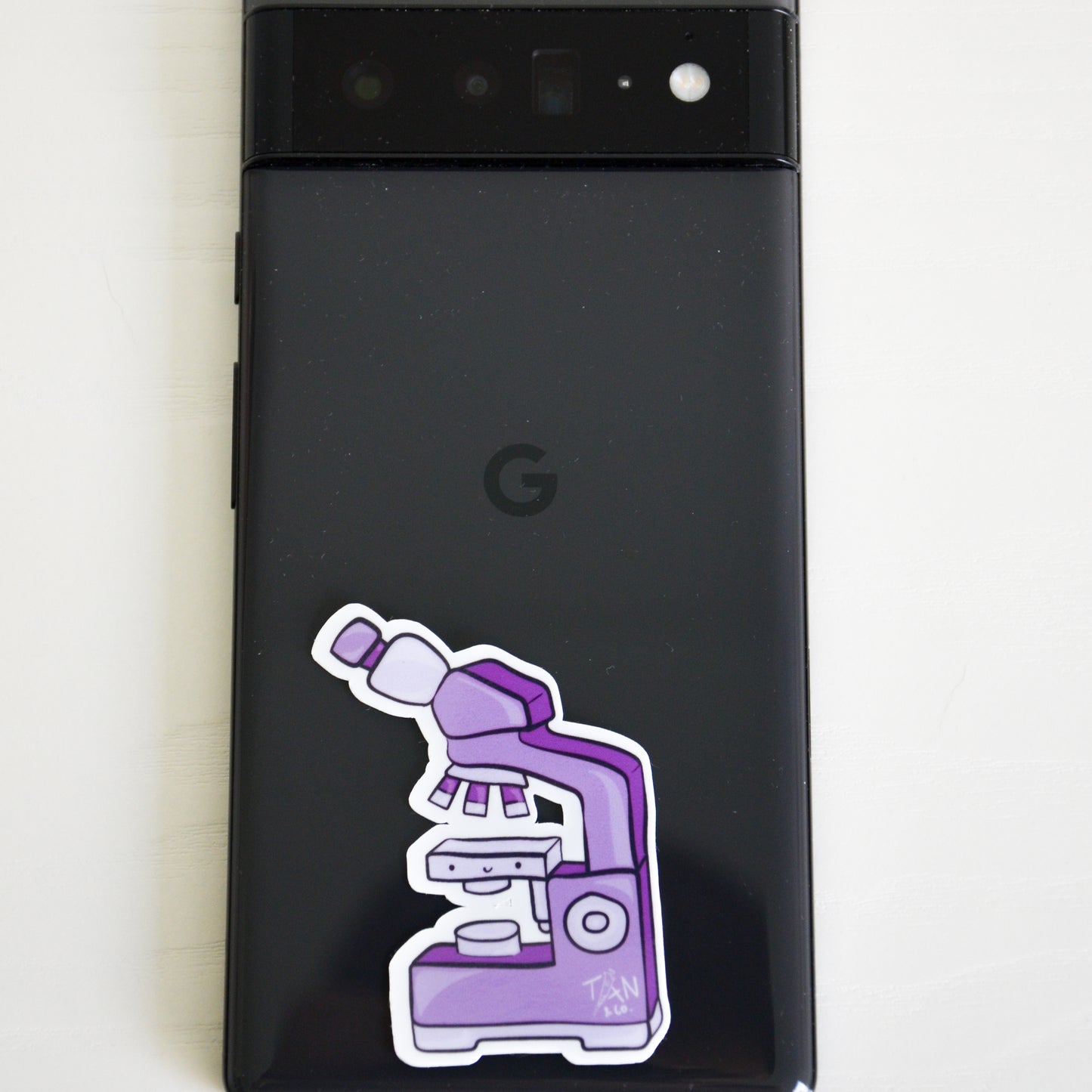 Purple microscope sticker on phone