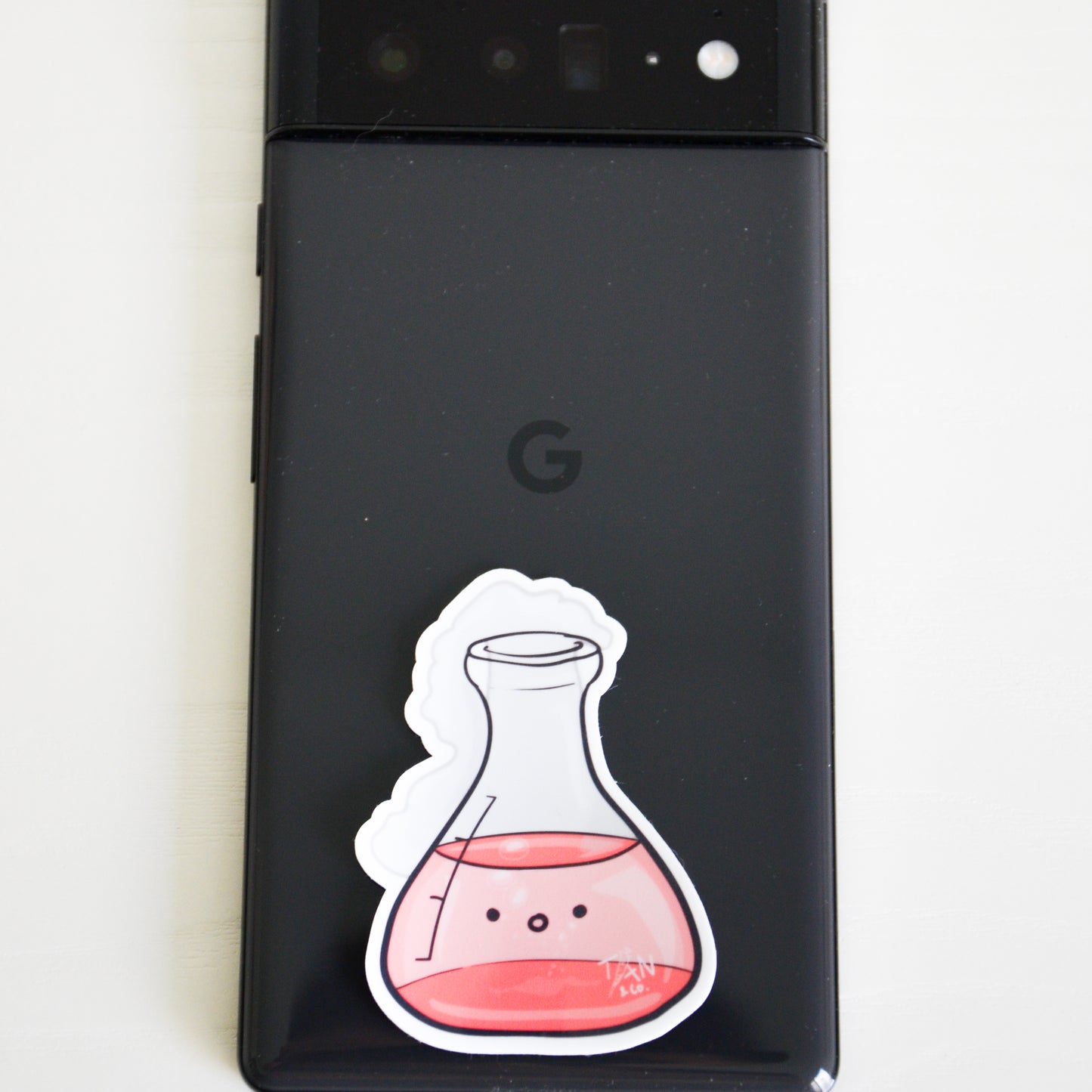 Red conical flask on phone